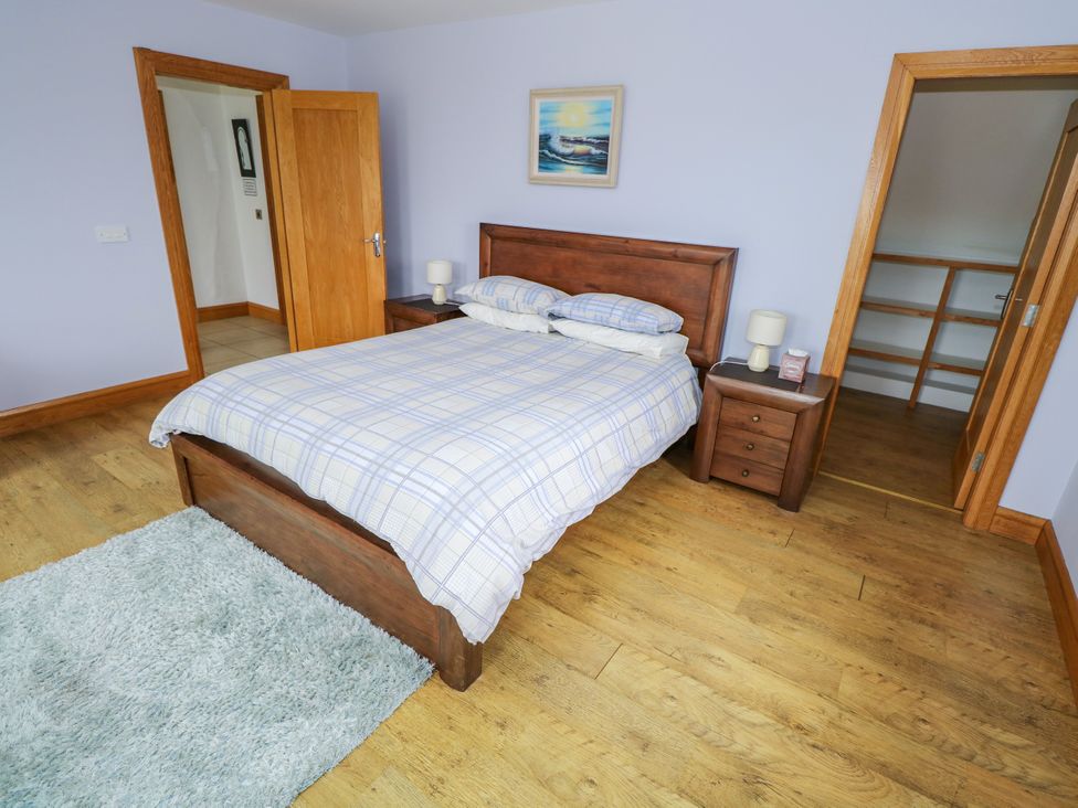 A bedroom with a bed and nightstand at Ocean Sail House Termon near Dungloe County Donegal
