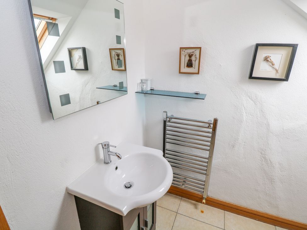 A bathroom with a sink and mirror at Ocean Sail House in Termon near Dungloe, County Donegal