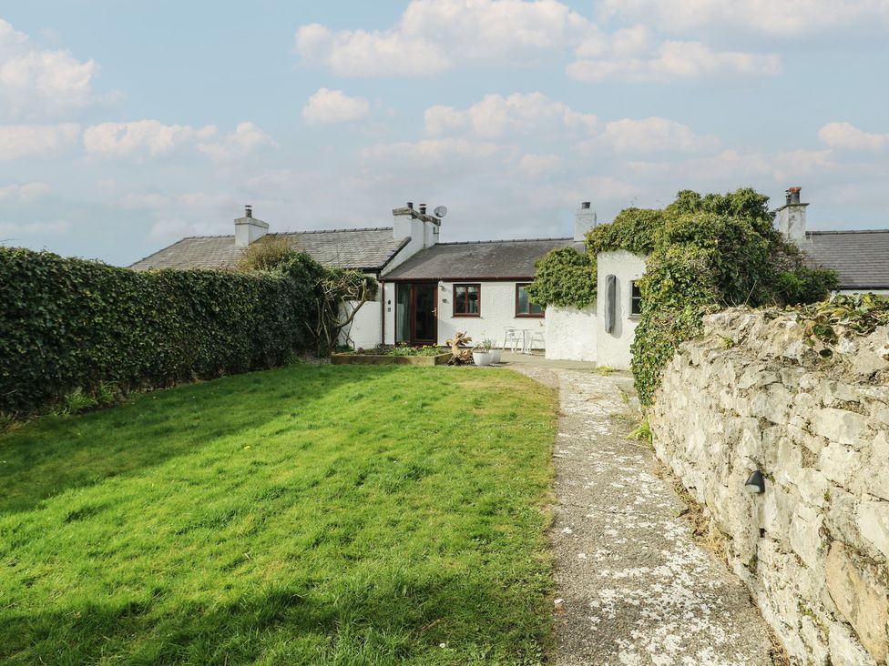 A house with a garden and pathway at Bwthyn Moelfre