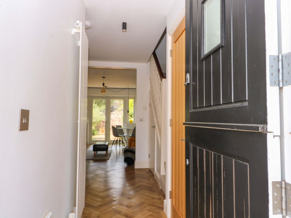 A hallway with a door and staircase at 2A The Mews, Langstone