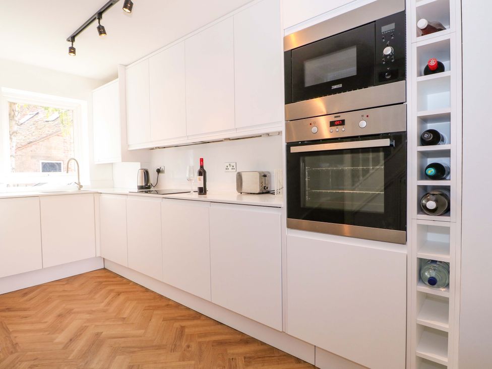 A kitchen with cabinets, sink and appliances at 2A The Mews in Langstone