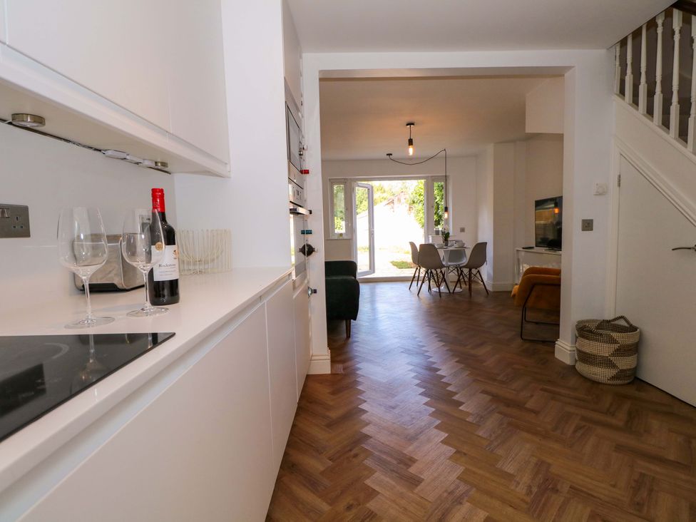 A kitchen with a view into the dining area at 2A The Mews Langstone