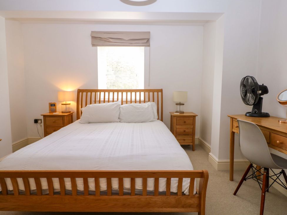 A bedroom with a bed and desk at 2A The Mews in Langstone