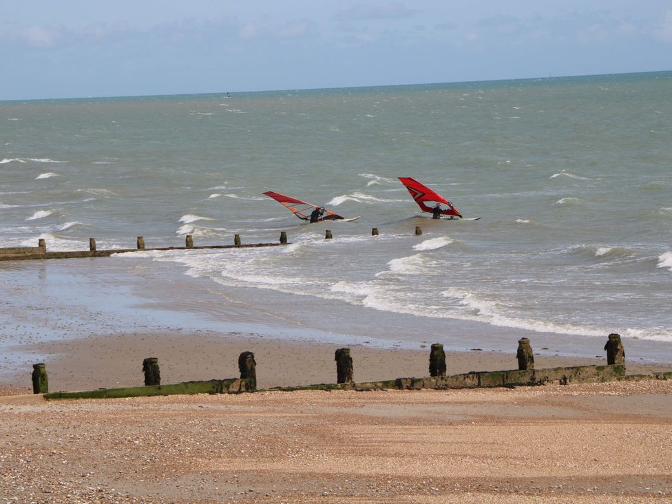 Two sailboarders on the water at the beach at 2A The Mews Langstone
