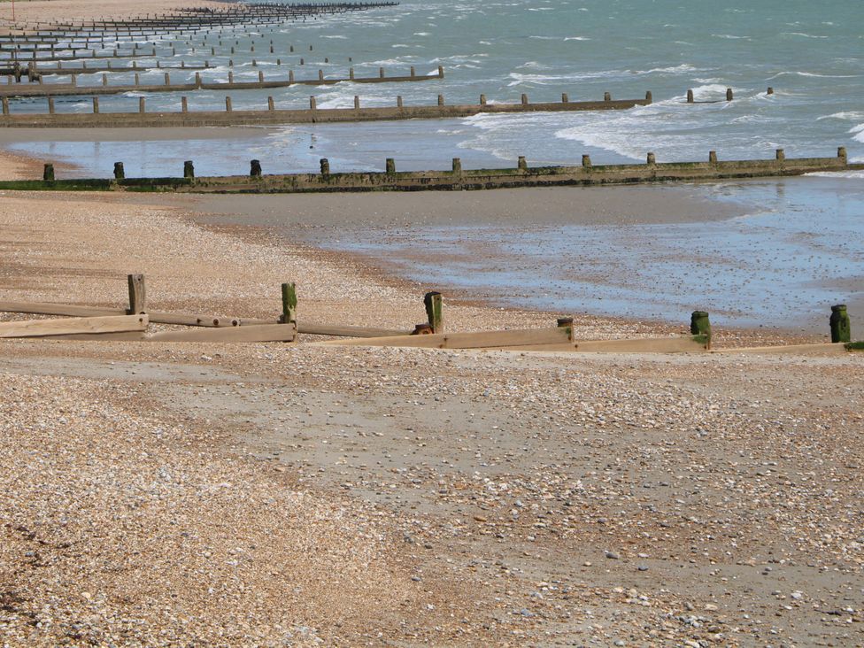 A beach with groynes and waves at 2A The Mews Langstone