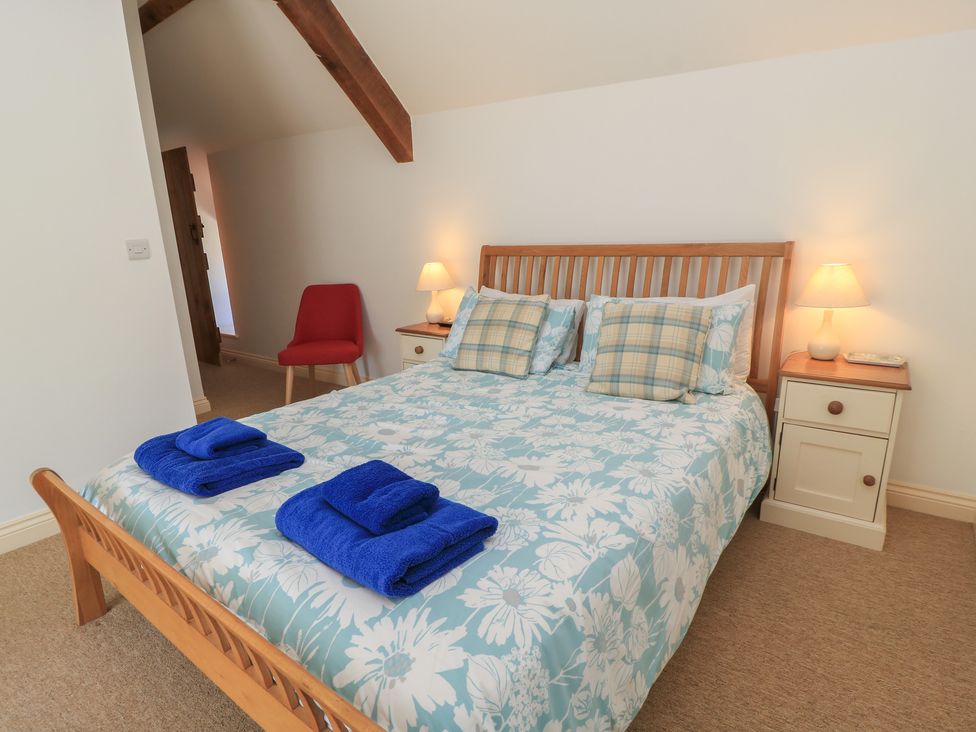 A bedroom with a bed and bedside table at Dale Barton in Wells