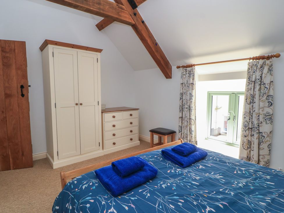 A bedroom with a bed and wardrobe at Dale Barton Wells