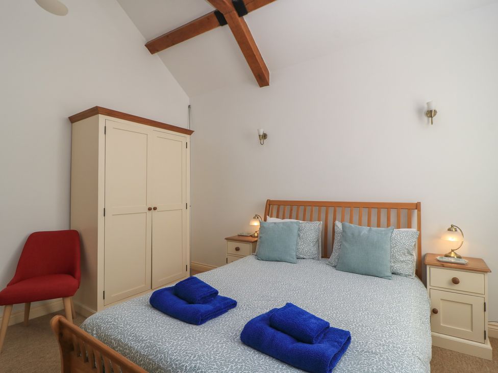 A bedroom with a bed and wardrobe at Dale Barton in Wells