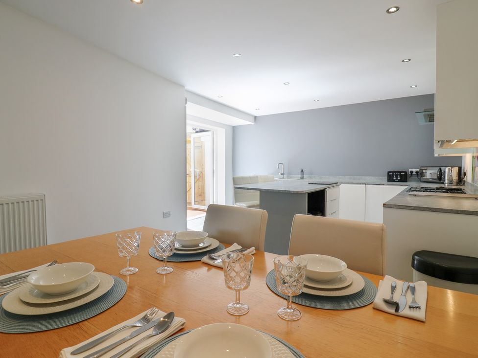 A dining room with a table set for meals at 38 The Parade Walton-On-The-Naze