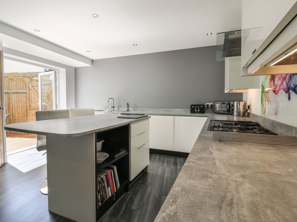 A kitchen with a countertop and stove at 38 The Parade Walton-On-The-Naze