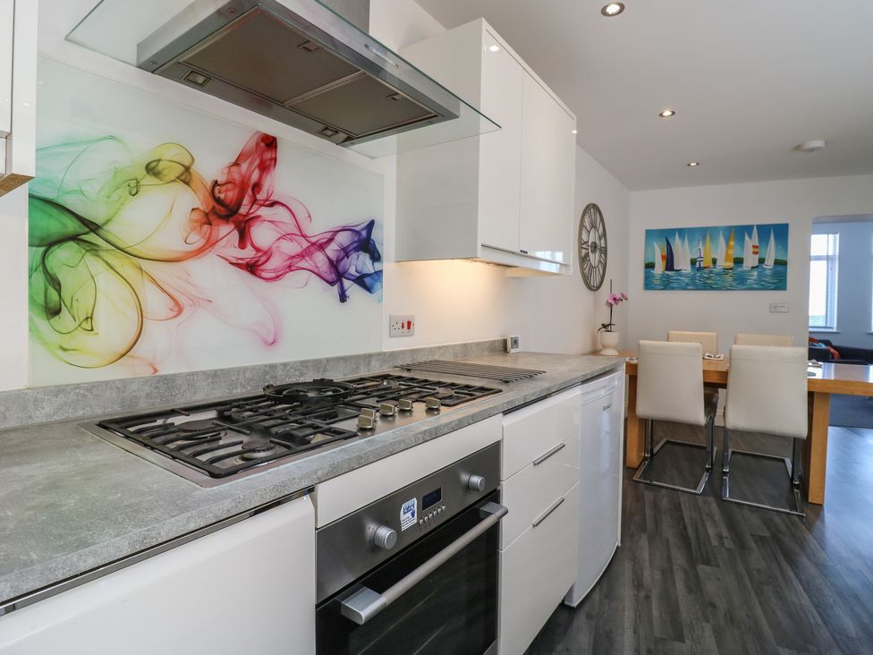 A kitchen with a gas stove and dining area at 38 The Parade Walton-On-The-Naze