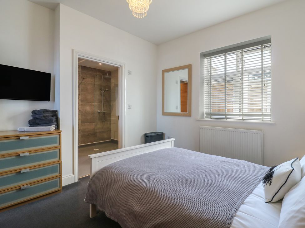A bedroom with a bed and a television at 38 The Parade Walton-On-The-Naze