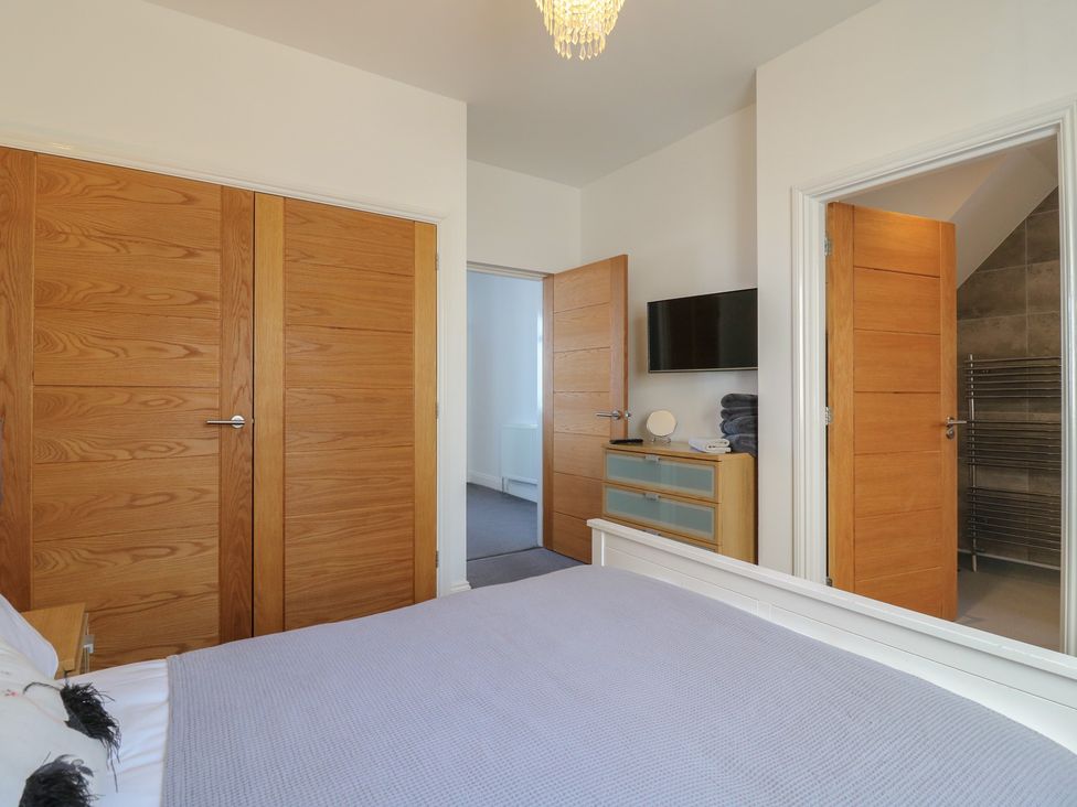 A bedroom with a bed and television at 38 The Parade Walton-On-The-Naze