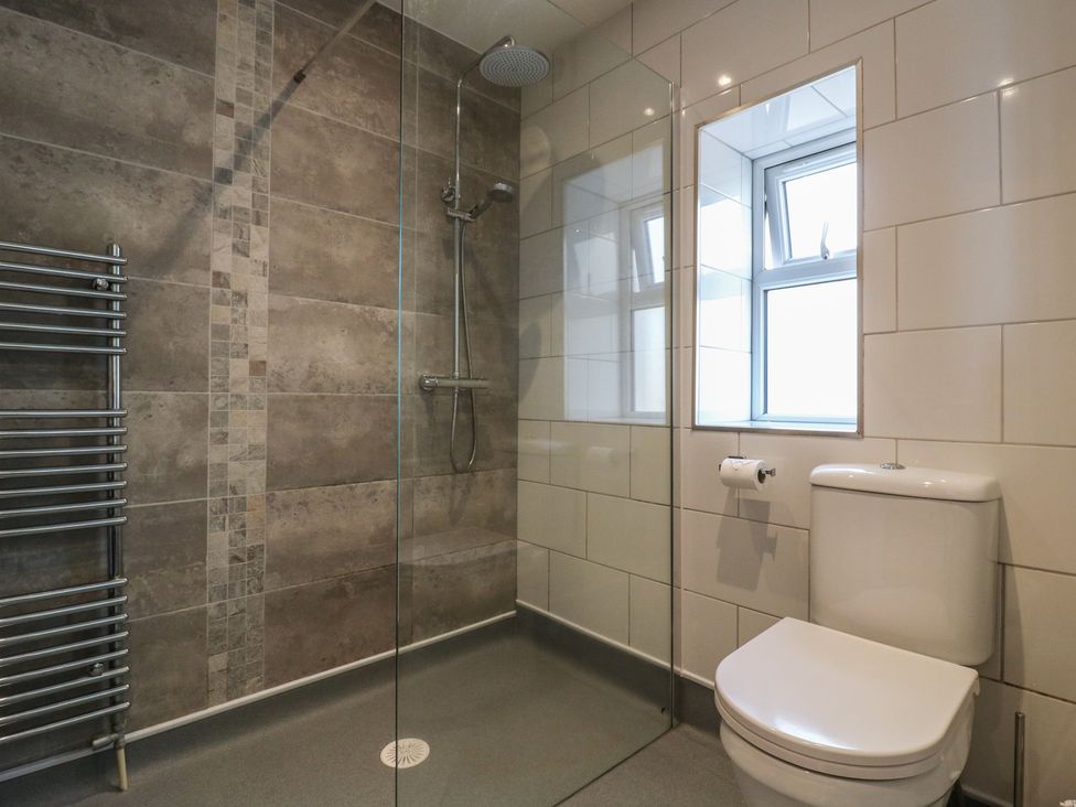 A bathroom with a shower and toilet at 38 The Parade Walton-On-The-Naze
