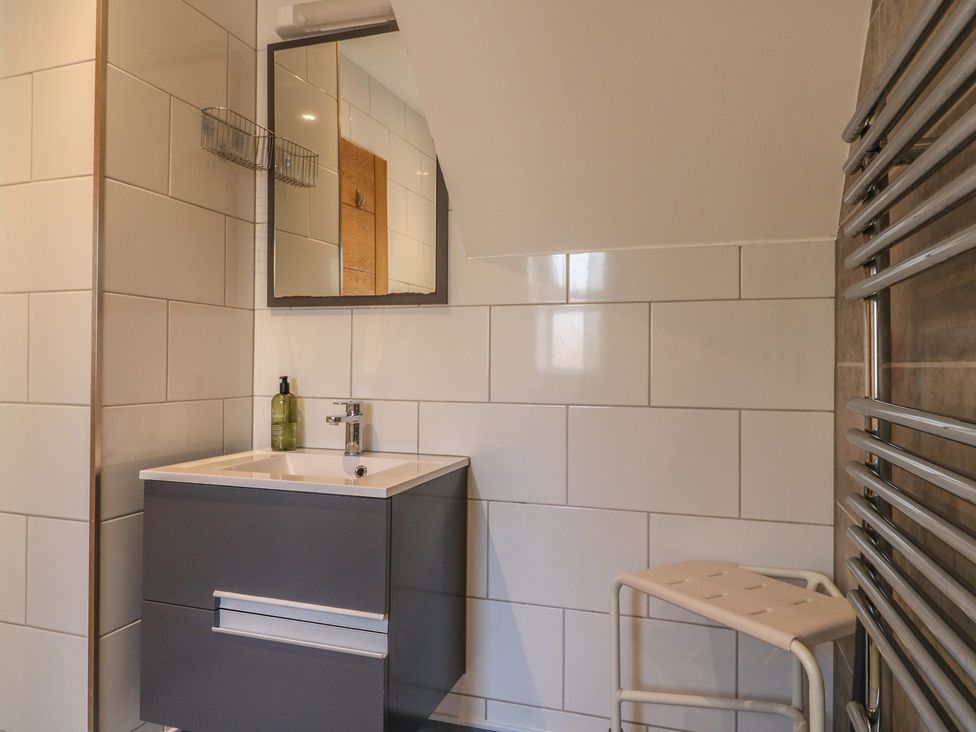 A bathroom with a wash basin and mirror at 38 The Parade Walton-On-The-Naze