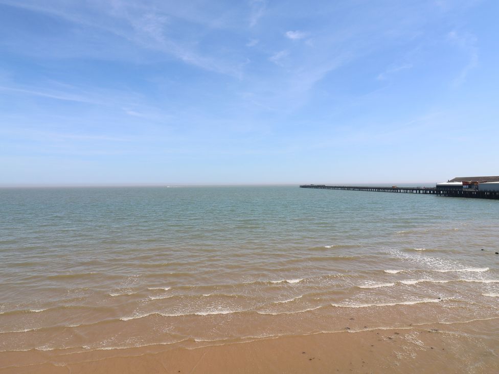 A view of the sea with a pier and sandy beach at 38 The Parade Walton-On-The-Naze