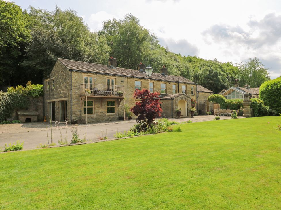 A house with a garden and pathway at Woodbottom Farm in Meltham