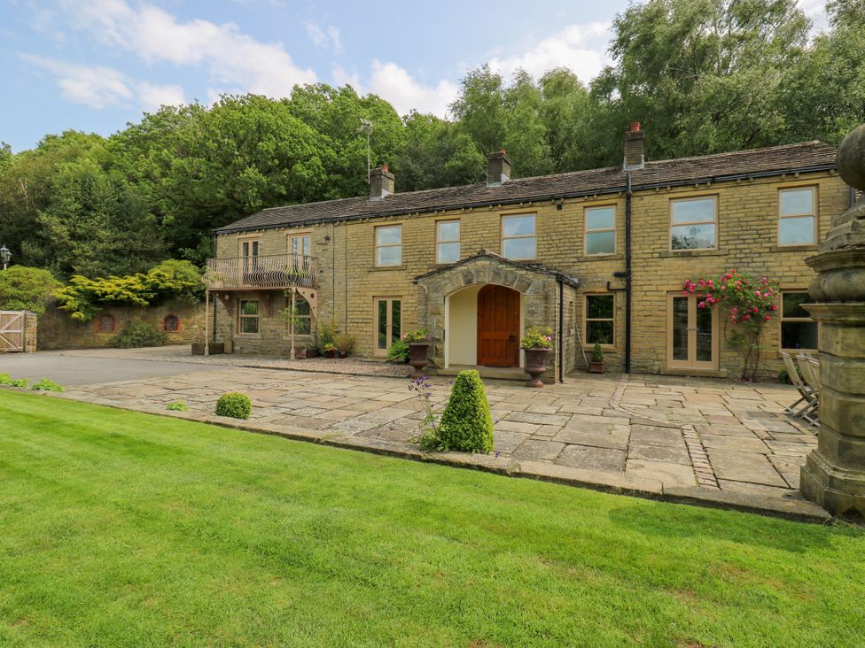 A house with a patio and balcony at Woodbottom Farm Meltham