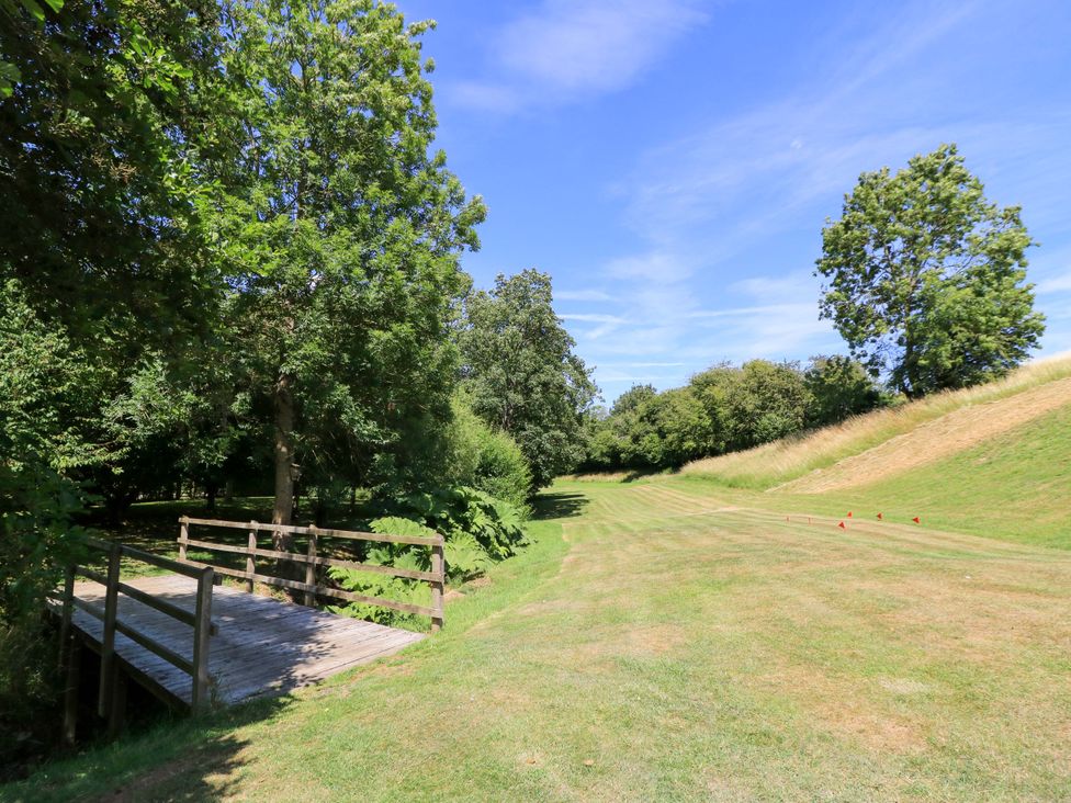 An outdoor area with a bridge and trees at Pheasant Cottage, Priston Village, BATH