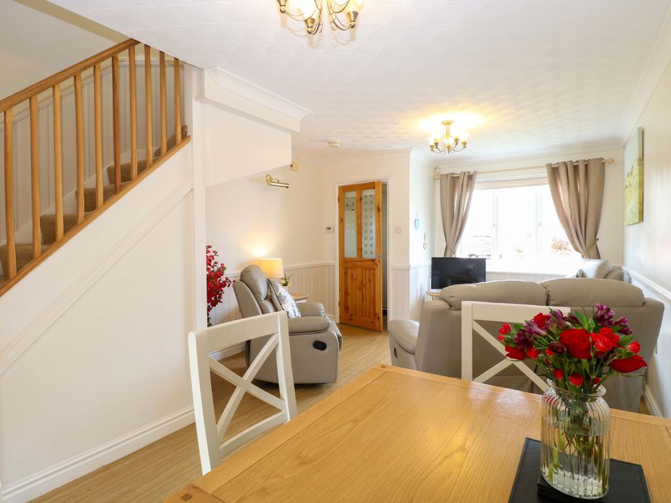 A living room with a sofa and a table at Breydon Cottage in Bradwell near Gorleston-On-Sea
