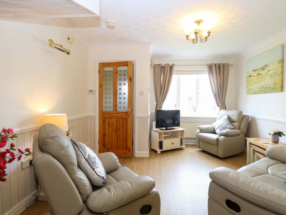 A living room with two recliner chairs and a television at Breydon Cottage in Bradwell near Gorleston-On-Sea