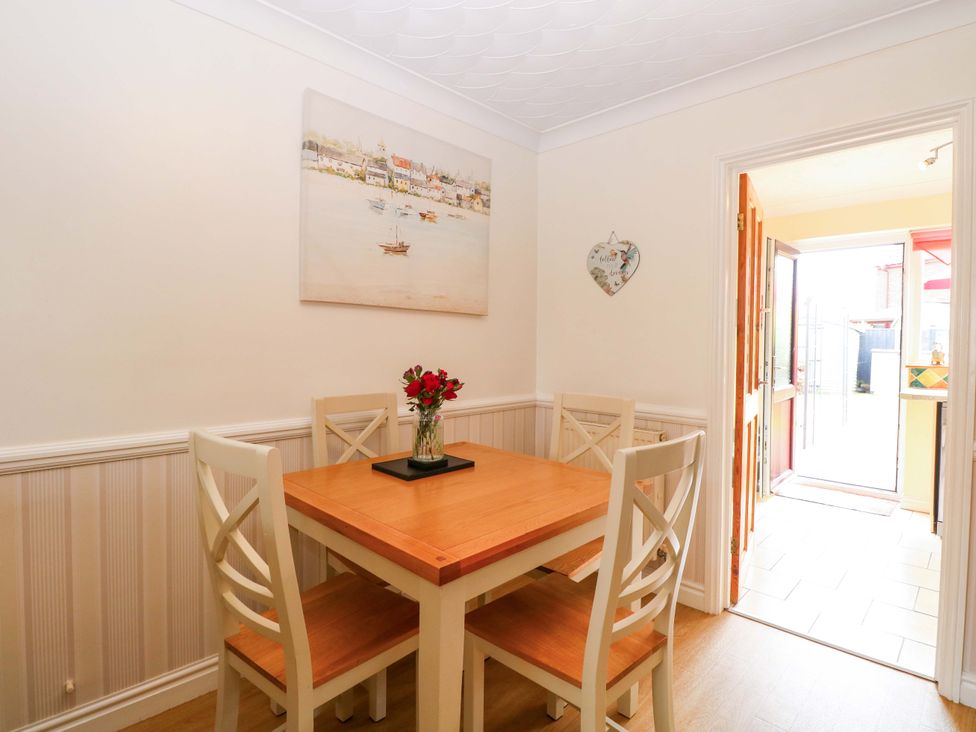 A dining room with a table and chairs at Breydon Cottage in Bradwell near Gorleston-On-Sea