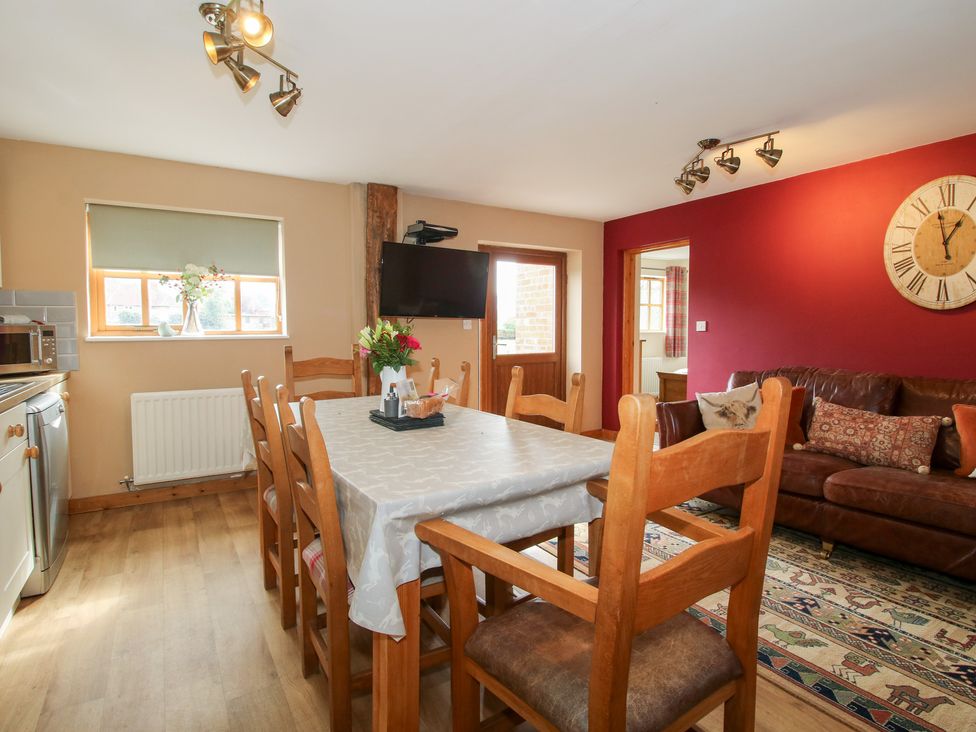 A dining room with a table and chairs at Old Hall Barn 2 Church Stretton