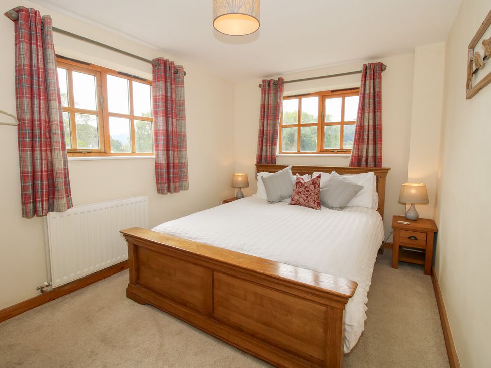 A bedroom with a bed and lamps at Old Hall Barn 2 Church Stretton
