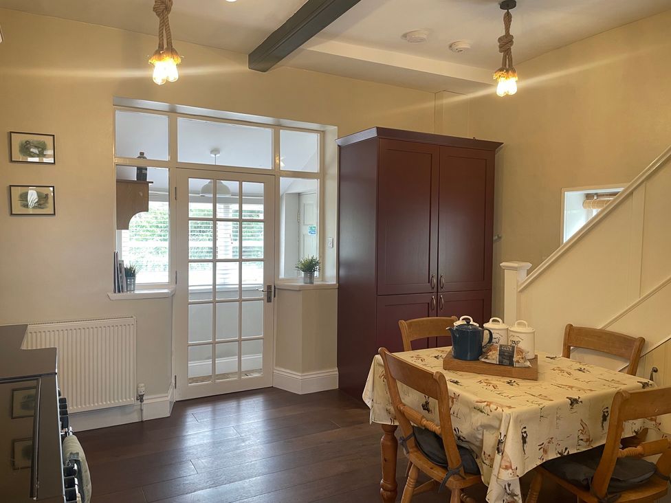 A kitchen with a table and chairs at Warren House Cottage in Wragby