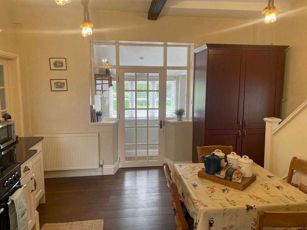 A kitchen with a table and chairs at Warren House Cottage in Wragby