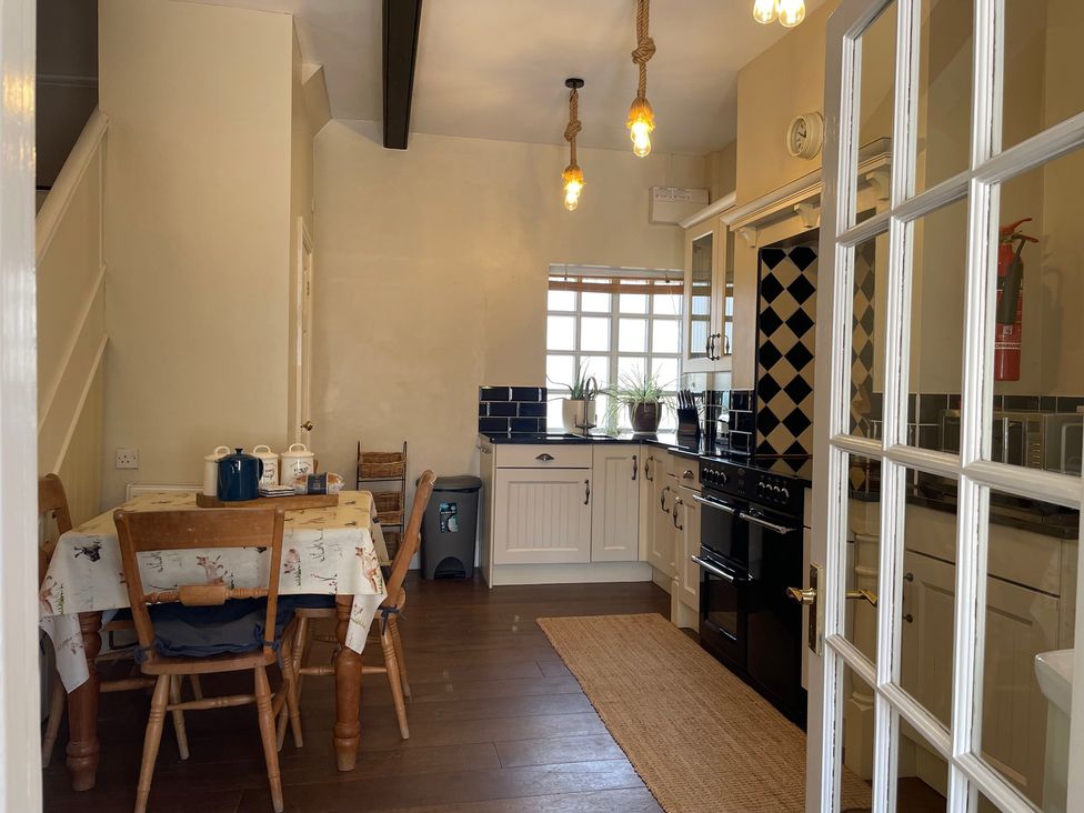 A kitchen with a table and chairs at Warren House Cottage in Wragby