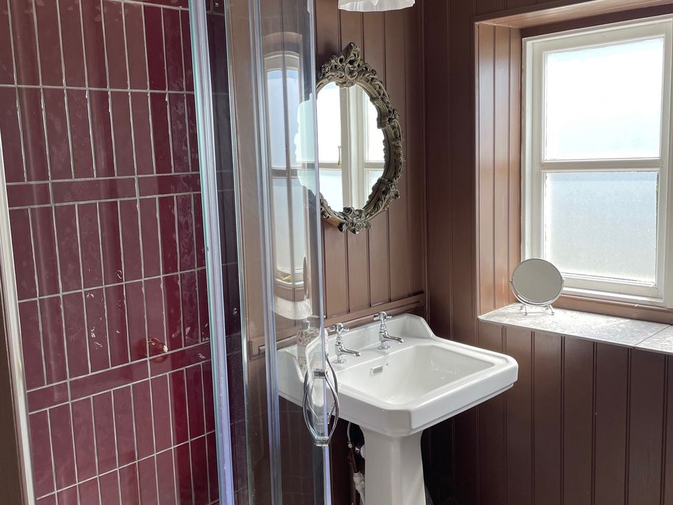 A bathroom with a shower and washbasin at Warren House Cottage in Wragby