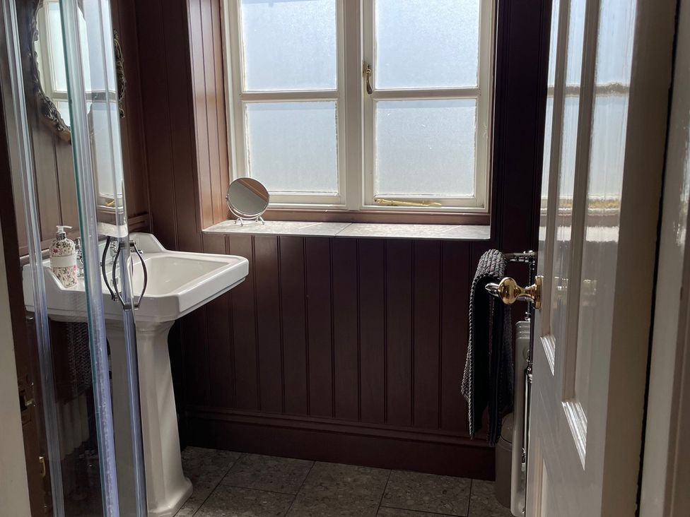 A bathroom with a sink and mirror at Warren House Cottage in Wragby