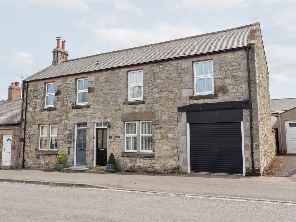 A house with windows and a garage at Hasting Dairy in North Sunderland near Seahouses