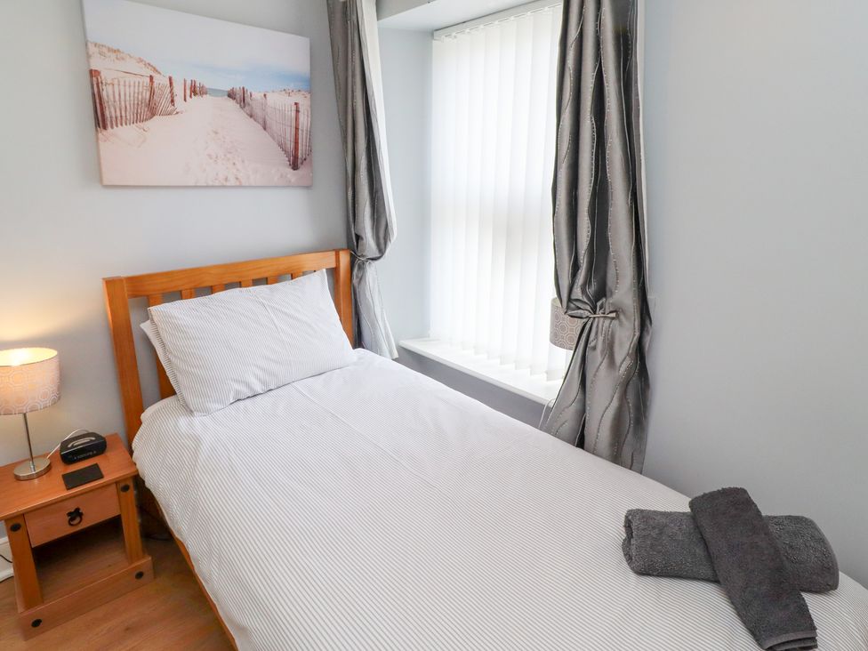 A bedroom with a single bed and window at Hasting Dairy in North Sunderland near Seahouses