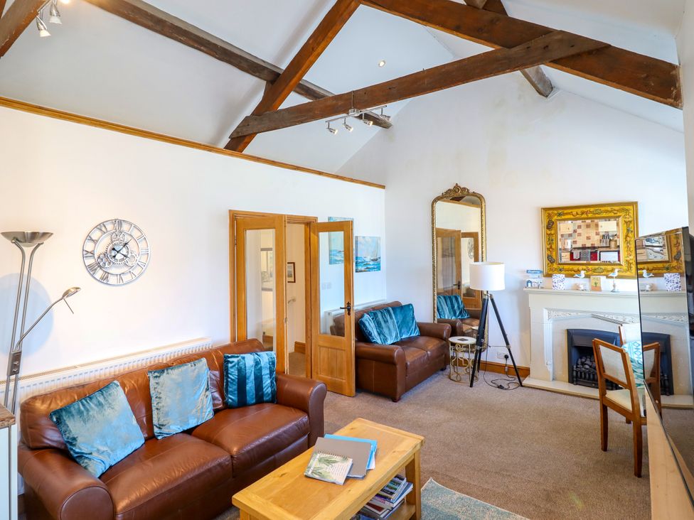 A living room with sofas and a coffee table at Bay View Apartment in Porthmadog