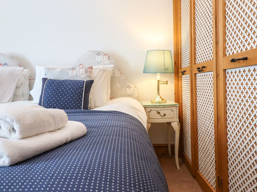 A bedroom with a bed and nightstand at Bay View Apartment in Porthmadog