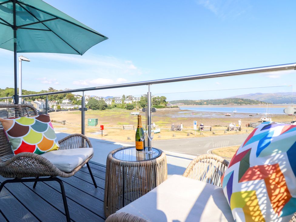 An outdoor seating area with a view of the water at Bay View Apartment Porthmadog