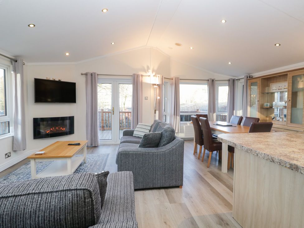 A living room with a sofa and dining area at Heights View in 