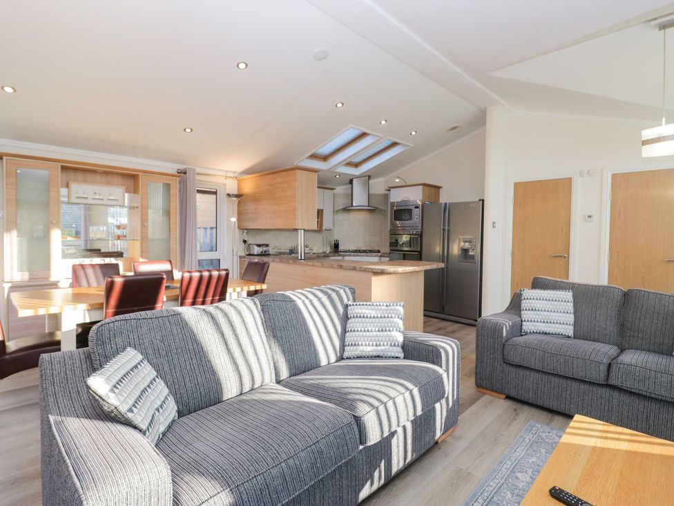 A living room and kitchen area with a sofa and dining table at Heights View