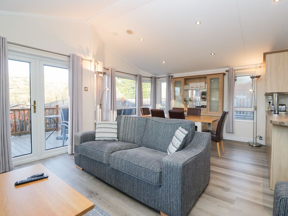 A living room with a sofa and dining area at Heights View