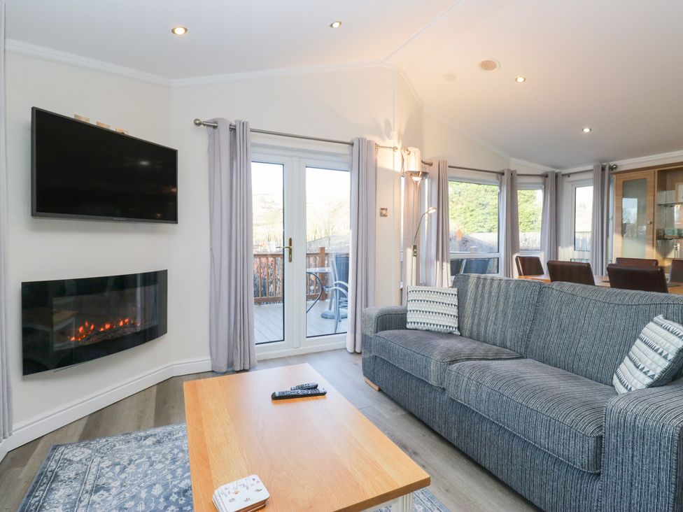 A living room with a television and fireplace at Heights View