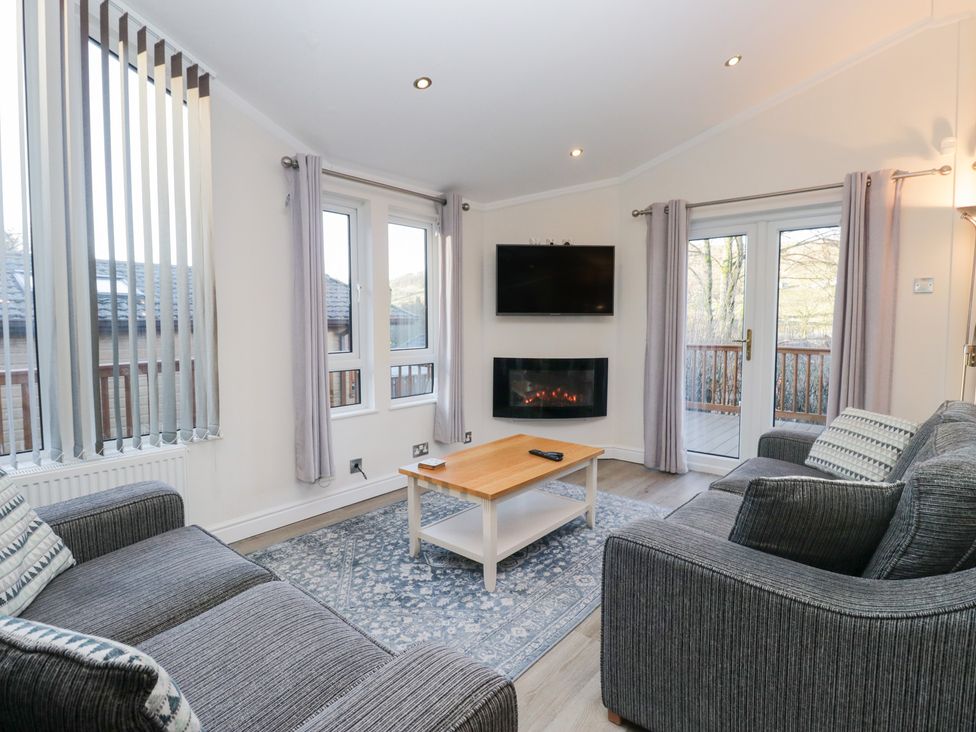 A living room with a tv and fireplace at Heights View