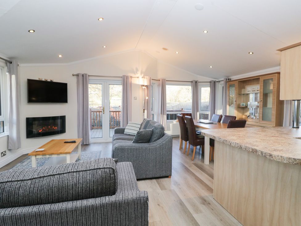A living room with a fireplace and dining table at Heights View