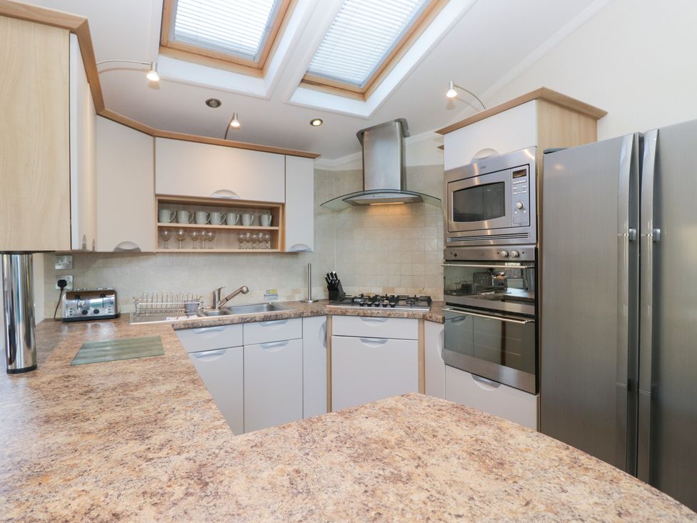A kitchen with appliances including a refrigerator and stove at Heights View