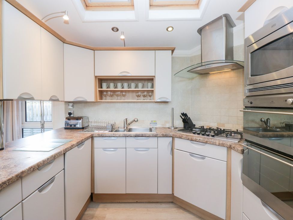 A kitchen with a sink, oven, and countertop at Heights View