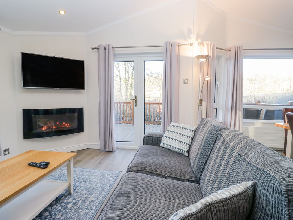 A living room with a television and fireplace at Heights View