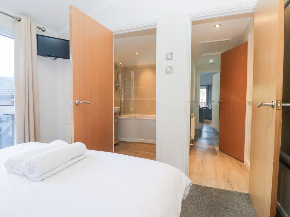 A bedroom with a view of a bathroom and television at Heights View 