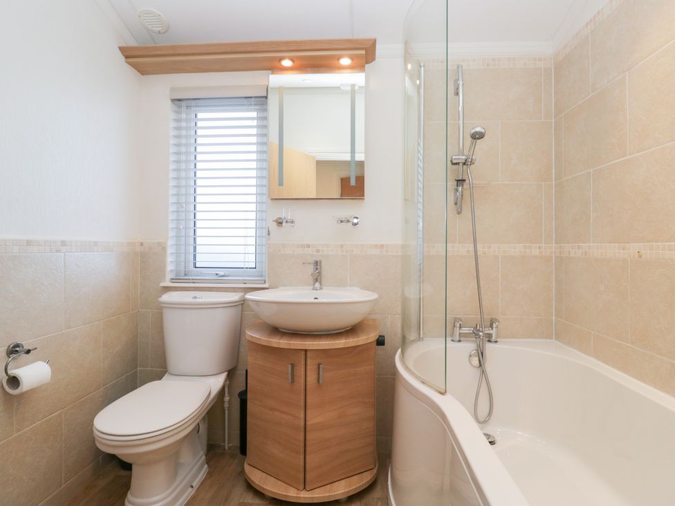 A bathroom with a toilet, sink, and bathtub at Heights View