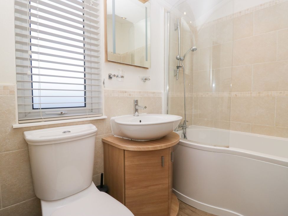 A bathroom with a toilet, sink, and shower at Heights View 